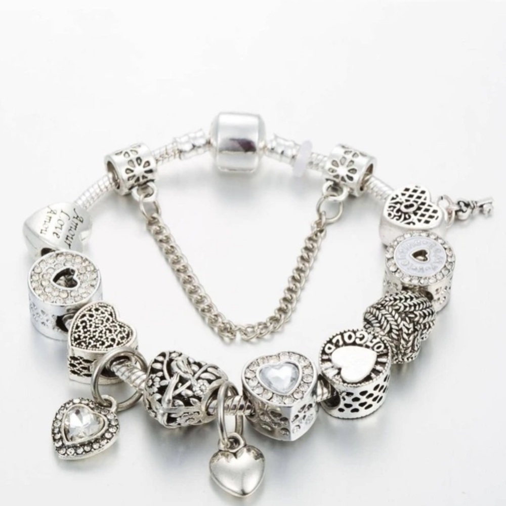 Silver Charm Bracelet with Intricate Designs and Safety Chain